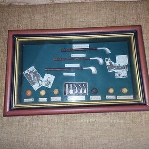 Shadowbox filled with miniature old-time golf memorabilia.